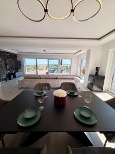 a living room with a table with plates and wine glasses at Villa Rima in Vonyarcvashegy