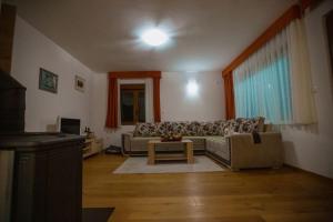 a living room with a couch and a table at Orange stan in Žabljak