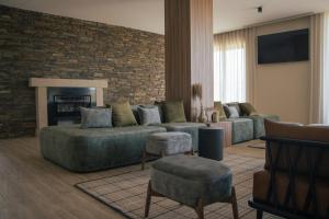 a living room with a couch and a fireplace at Quinta do Roso - Douro Wine Estate - by FERO in Lamego