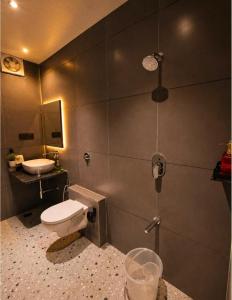 a bathroom with a toilet and a sink at The Peach Boho in Mount Ābu +19 photos