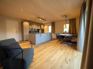 a living room with a kitchen and a dining room at Fuxbau Allgäu in Argenbühl