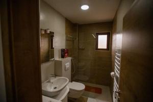 a small bathroom with a toilet and a sink at Orange stan in Žabljak +9 photos