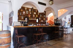 a bar with stools and a counter in a room at Gîte Raid Oriental in Taforhalt