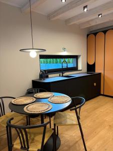 a kitchen with a table with chairs and a sink at Stodoły Północ in Debina