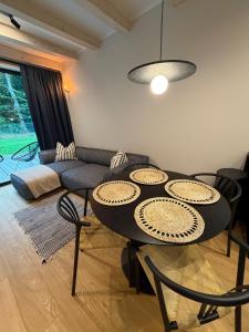 a living room with a table and a couch at Stodoły Północ in Debina