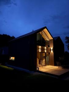 a house at night with the lights on at Stodoły Północ in Debina +6 photos