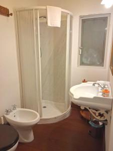 a bathroom with a shower and a toilet and a sink at Casa Angioletta in Taormina +13 photos