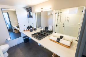 a bathroom with a sink and a shower at City24 Condo Hotel Little Italy Mission Hills in San Diego +84 photos