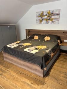 a bed with flowers on it in a bedroom at Zelena reka 4 in Vrhpolje +14 photos
