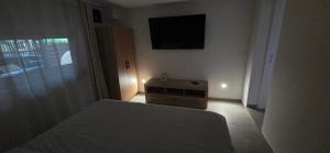 a bedroom with a bed and a flat screen tv at Melody Apartment Kutina in Kutina