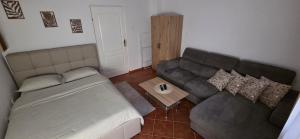 a living room with a couch and a table at Melody Apartment Kutina in Kutina