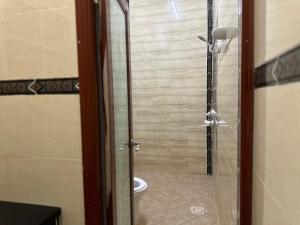 a bathroom with a glass shower with a toilet at Simple Beach Stay 100m to Dahariz Beach Salalah in Salalah +6 photos