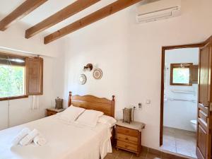 a bedroom with a bed and a mirror and a tub at Can Xicu Castello in San Ferrán de ses Roques +99 photos