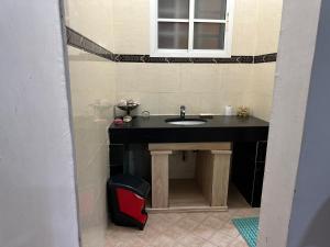 a bathroom with a black sink and a window at Simple Beach Stay 100m to Dahariz Beach Salalah in Salalah