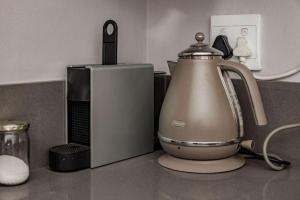 a kitchen counter with a tea kettle and a microwave at Santa Stay in Stellenbosch