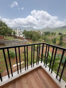 a balcony with a view of the mountains at kailasa Villa in Karjat