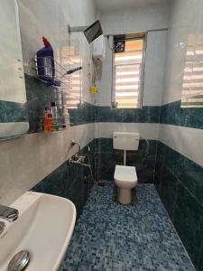 a bathroom with a white toilet and a sink at kailasa Villa in Karjat