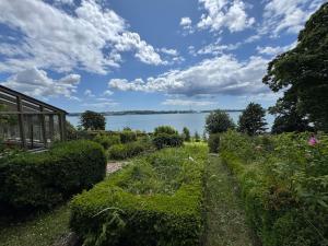 a garden with a view of the water at Harbour view Tree House in Cobh +32 photos