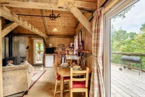 a kitchen and dining room with a table and chairs at 1 Bed in Chulmleigh oc-74133 in Eggesford