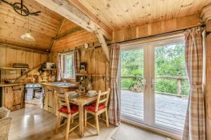 a kitchen with a table and chairs in a cabin at 1 Bed in Chulmleigh oc-74133 in Eggesford