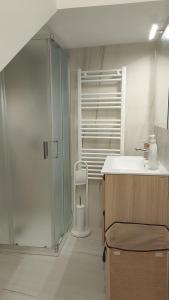 a bathroom with a glass shower and a sink at House Mare Blu in Balestrate