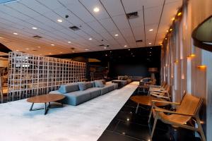 a lobby with a couch and chairs and tables at Enjoy Punta del Este in Punta del Este