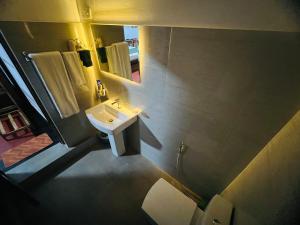 a bathroom with a sink and a mirror at Coffee Cabanas in Matale