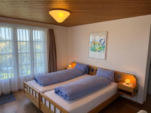 a bedroom with two beds with blue pillows at Hirschen Wald - Gasthaus & Bäckerei in Wald +160 photos