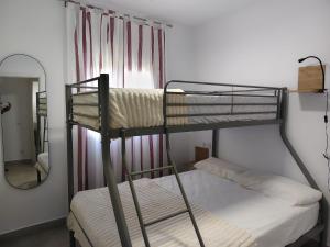 two bunk beds in a room with a mirror at La OSTRA 33 in Chiclana de la Frontera +16 photos