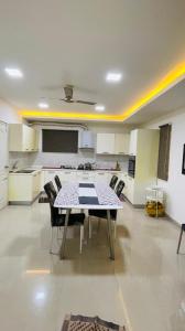 a dining room with a table and chairs in a kitchen at Blue Breeze Villa in Mahabalipuram