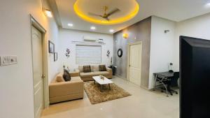 a living room with a couch and a ceiling at Blue Breeze Villa in Mahabalipuram