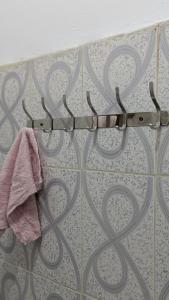 a towel hanging from a towel rack on a wall at CJ Apartments in Kapchorwa