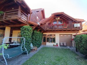 a house with a balcony and a yard at Pasager House in Sovata +23 photos