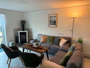 a living room with a couch and a table at Apartmán U našich in Jeseník