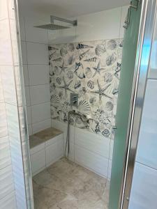 a shower with a glass door in a bathroom at Apartmán U našich in Jeseník +20 photos