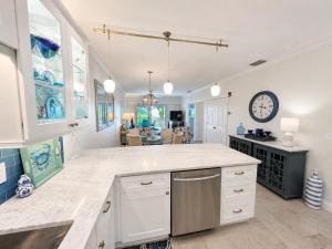 a large kitchen with a counter top and a clock at Old Marco Inne 403 in Marco Island