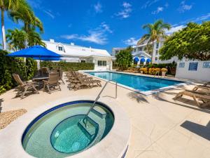 a swimming pool with a hot tub next to a house at Old Marco Inne 403 in Marco Island