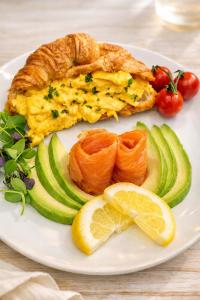 a plate of food with an omelet and vegetables at Highlander House Boutique in Rothesay
