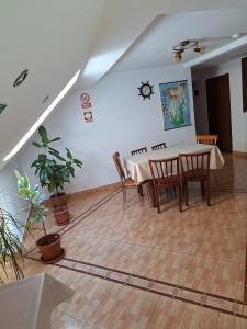 a dining room with a table and chairs at Vila Simona in Călimăneşti +7 photos