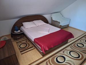 a model of a bedroom with a bed and a chair at Vila Simona in Călimăneşti