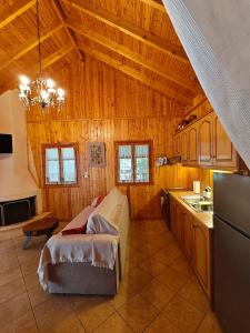 a kitchen with a couch and a table in a room at Mountain Nook Melissourgoi in Melissourgoí