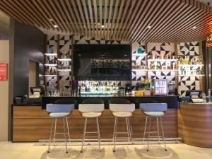 a bar with four stools in front of a counter at ibis Lima Larco Miraflores in Lima +158 photos