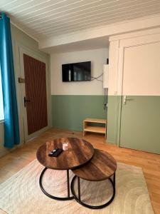 a living room with a table and two stools at Écrin de barr in Barr