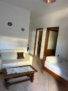 a living room with a couch and a table at Eljo Apartment in Asim Zeneli