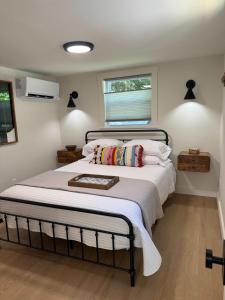 a bedroom with a bed with white sheets and a window at Sunapee Getaway With Lake Access in Sunapee