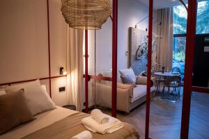 a bedroom with a bed and a living room at Castelar Urban Suites in Badajoz