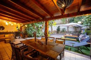 a living room with a wooden table and chairs at Portrait Boutique Guesthouse in Valencia