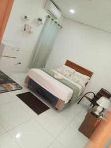 a bedroom with a bed in a white room at Hospedaje Alexa in Asunción