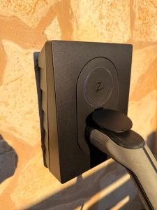 a speaker attached to a wall with a pair of scissors at EllaVis Apartments in Vis