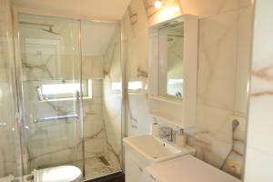 a bathroom with a toilet and a sink and a shower at Residence Rudaj in Vlorë +34 photos